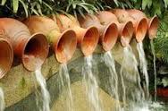 clay pots pouring water